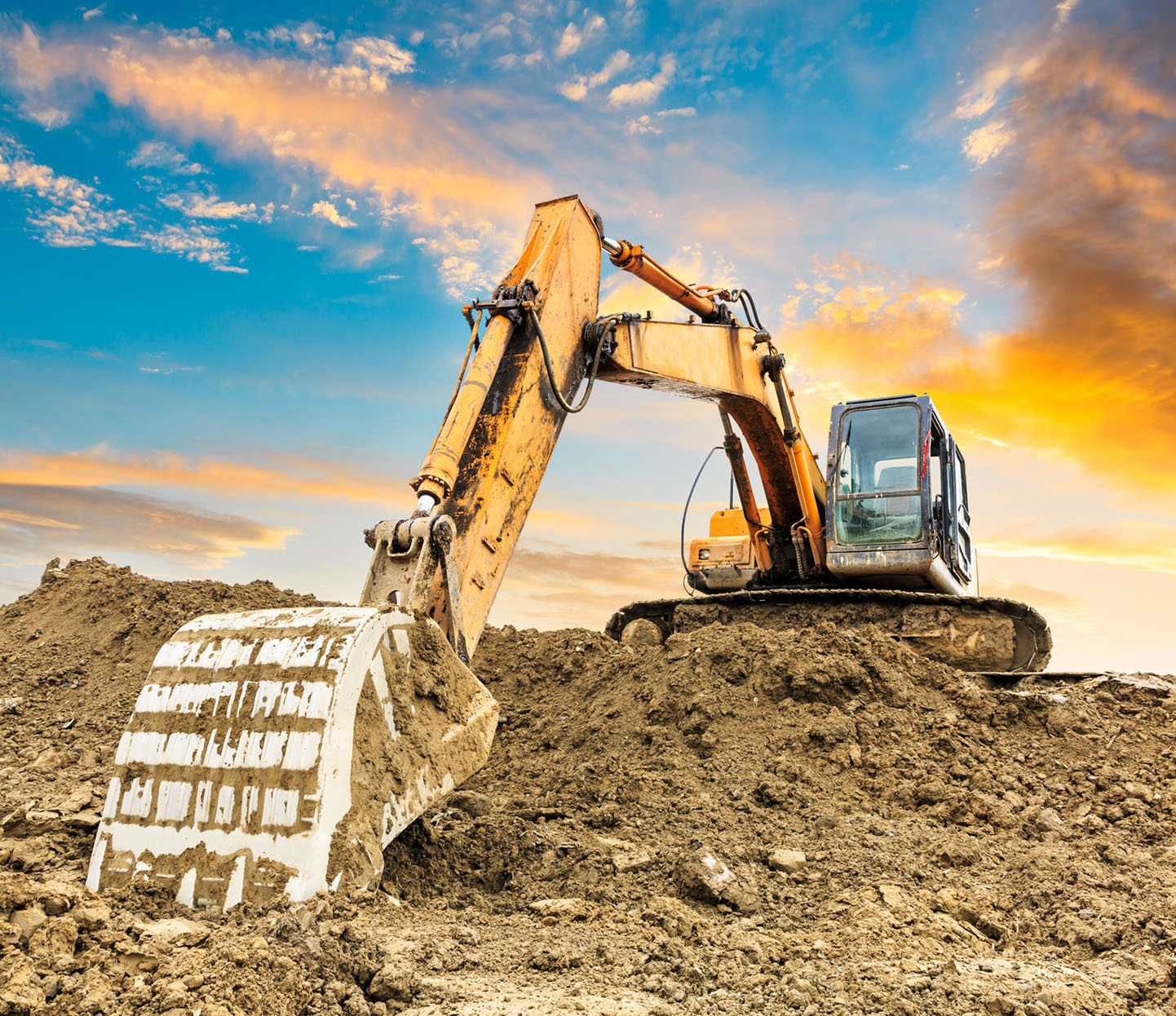 Excavator scooping dirt