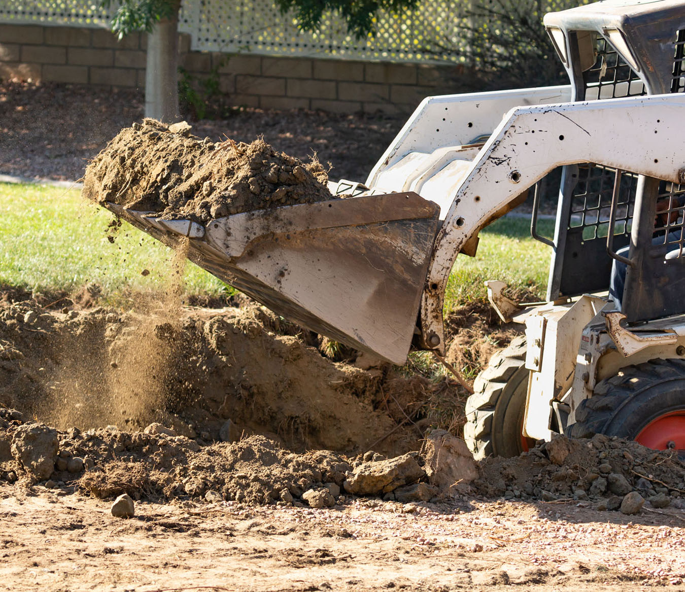 Mini excavator hauling dirt